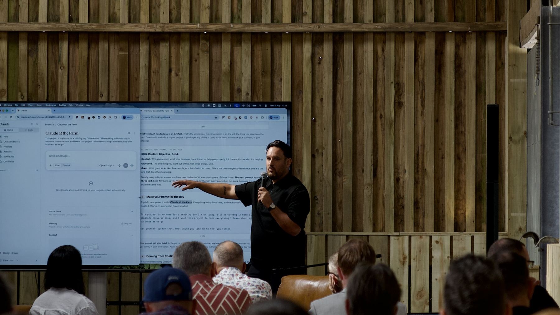 Liam Ray speaking to a room of people working on laptops