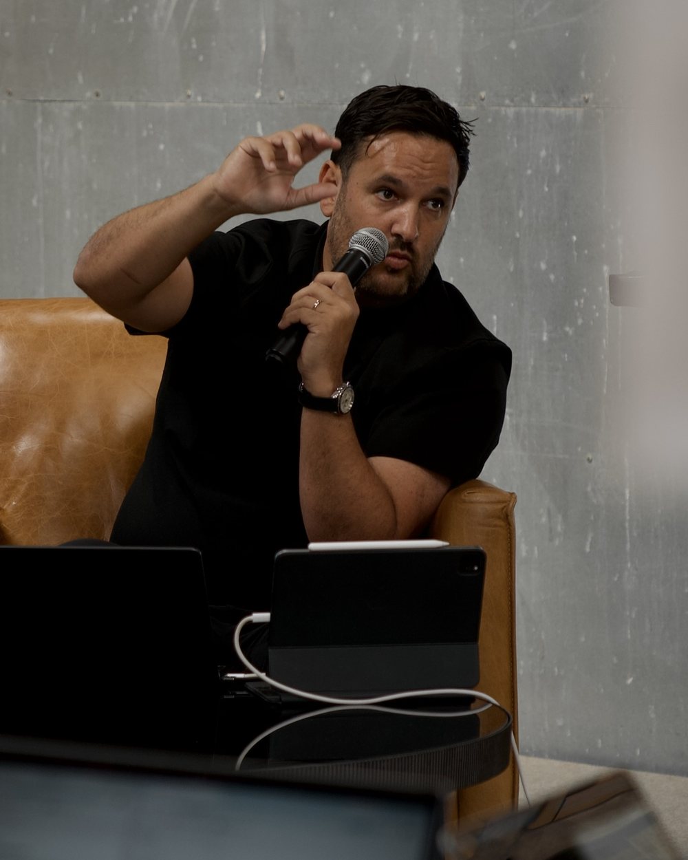 Liam Ray seated with a microphone